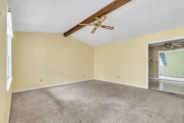 an empty room with windows & dryer
