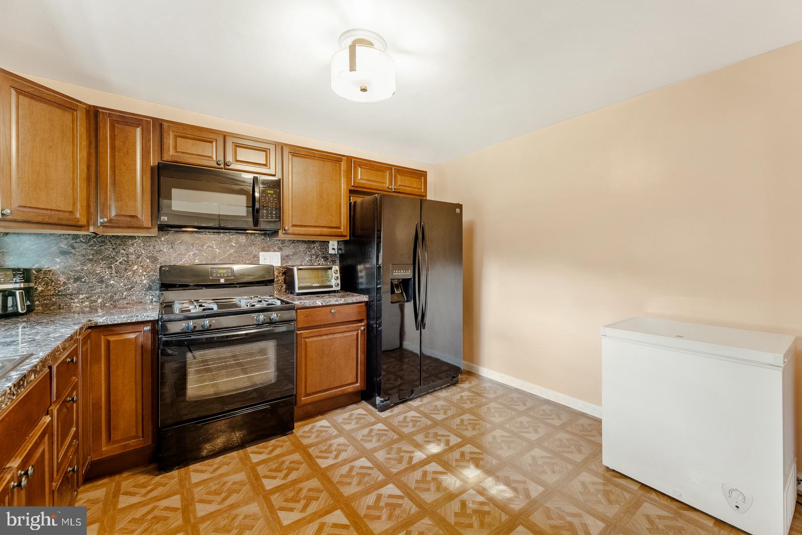 823 Rennard Street Philadelphia, PA 19116 - Photo 12 of 40 Modern kitchen with warm wood tones.