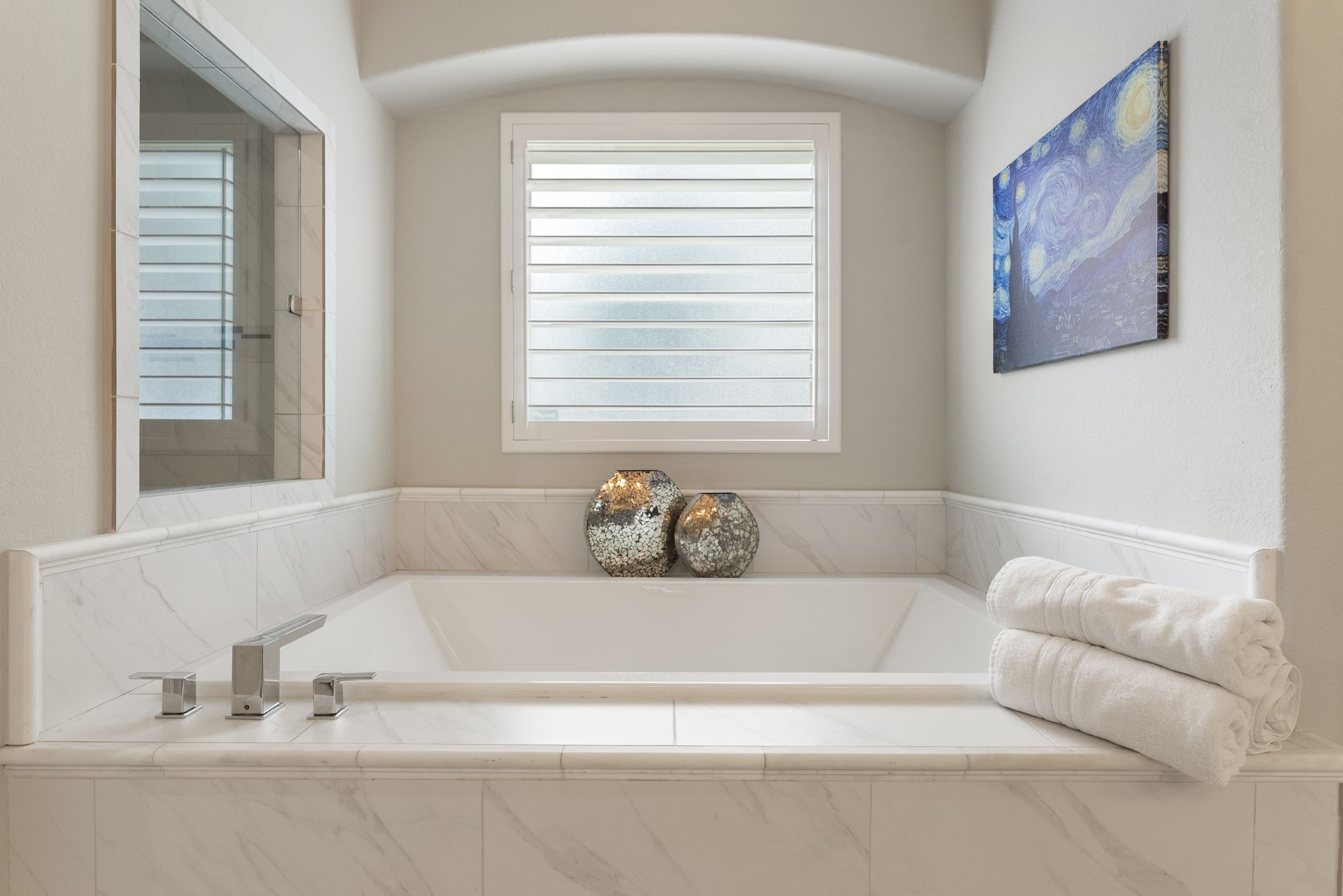25607 Muirfield Bend Court Spring, TX 77389 - Photo 17 of 30 Relax and unwind in the spa-inspired soaking tub, beautifully framed by timeless tilework and positioned beside the oversized walk-in shower for a true retreat-like experience.