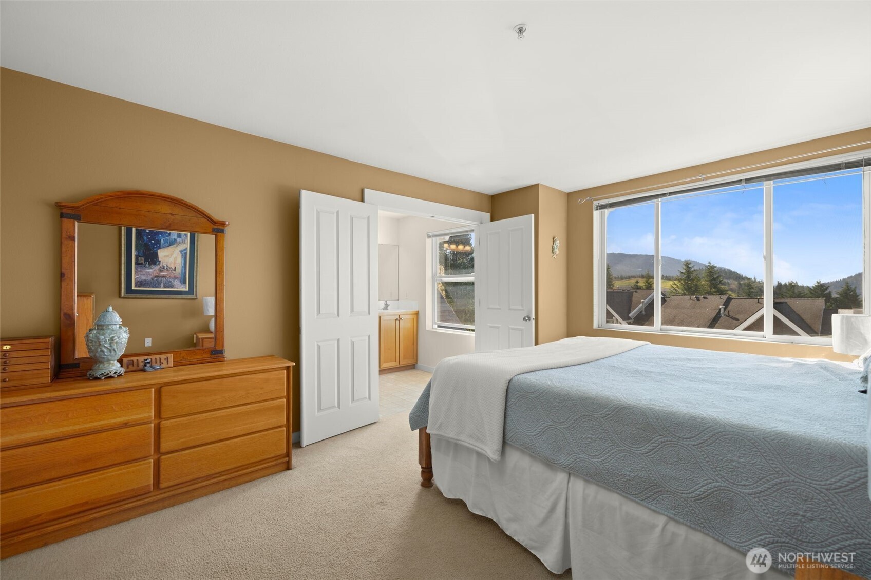 23120 Southeast Black Nugget Road, Unit E1 Issaquah, WA 98029 - Photo 15 of 39 a bedroom with a bed and a window