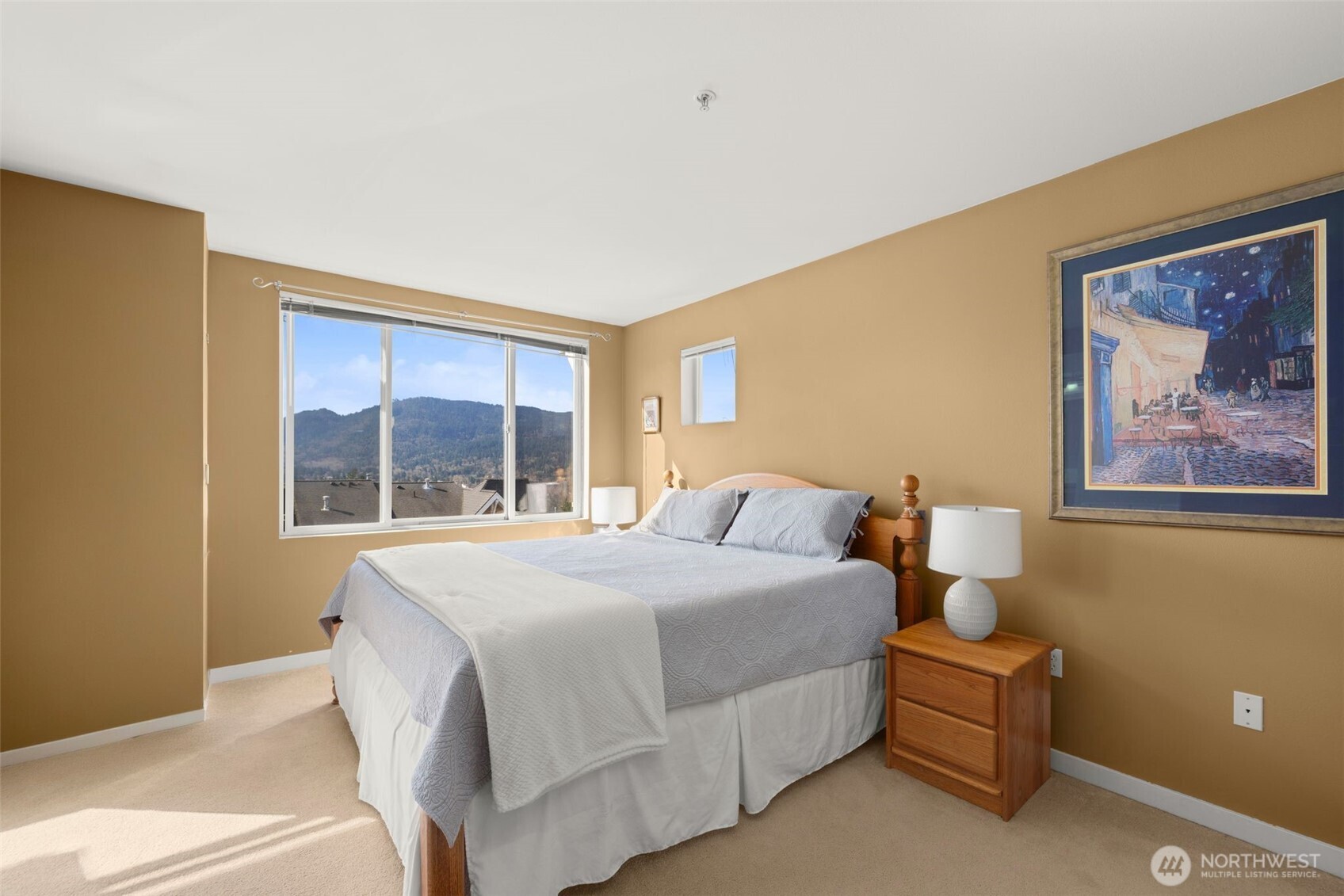 23120 Southeast Black Nugget Road, Unit E1 Issaquah, WA 98029 - Photo 16 of 39 a bedroom with a bed and a large window