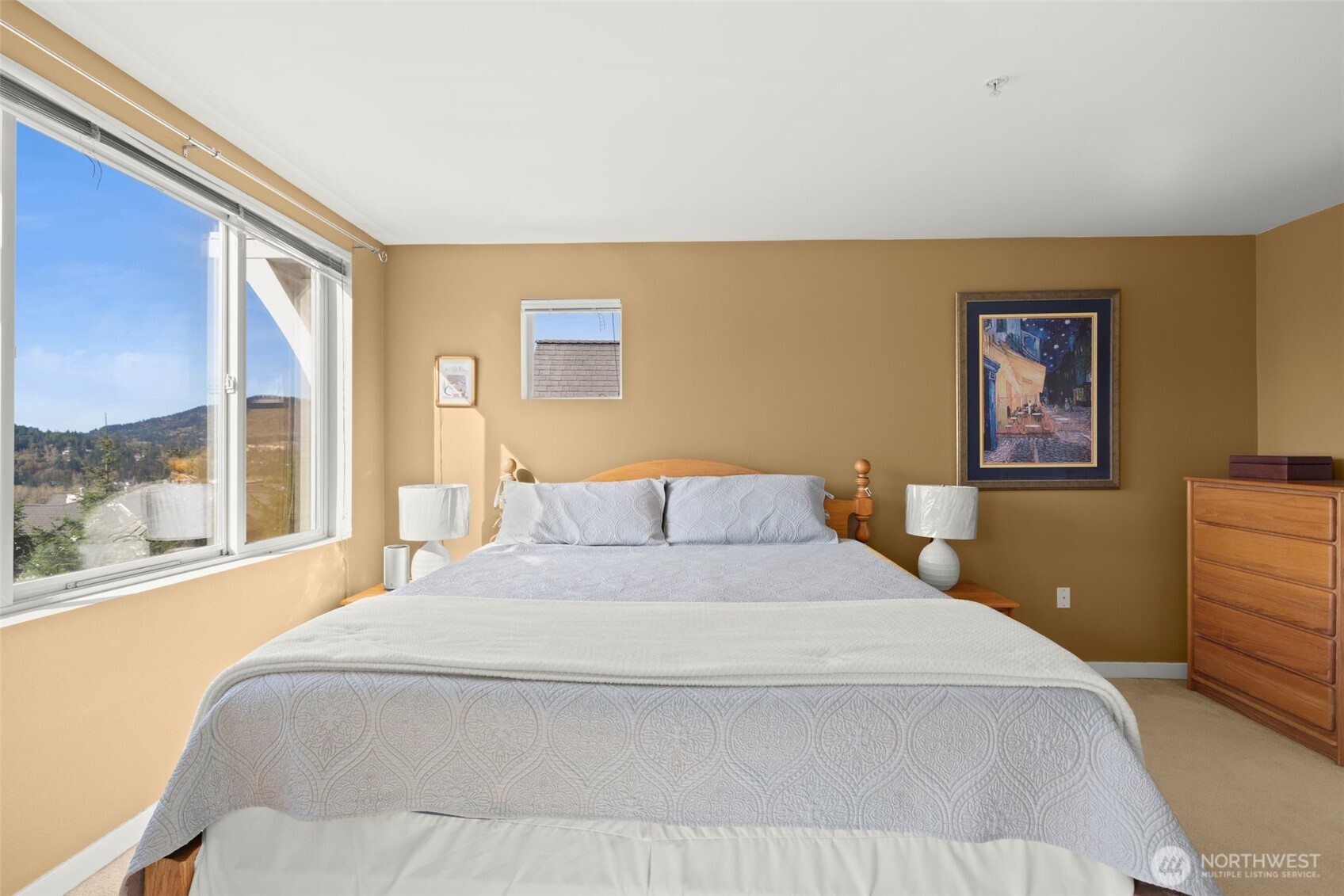 23120 Southeast Black Nugget Road, Unit E1 Issaquah, WA 98029 - Photo 17 of 39 a bedroom with a large bed and a large window