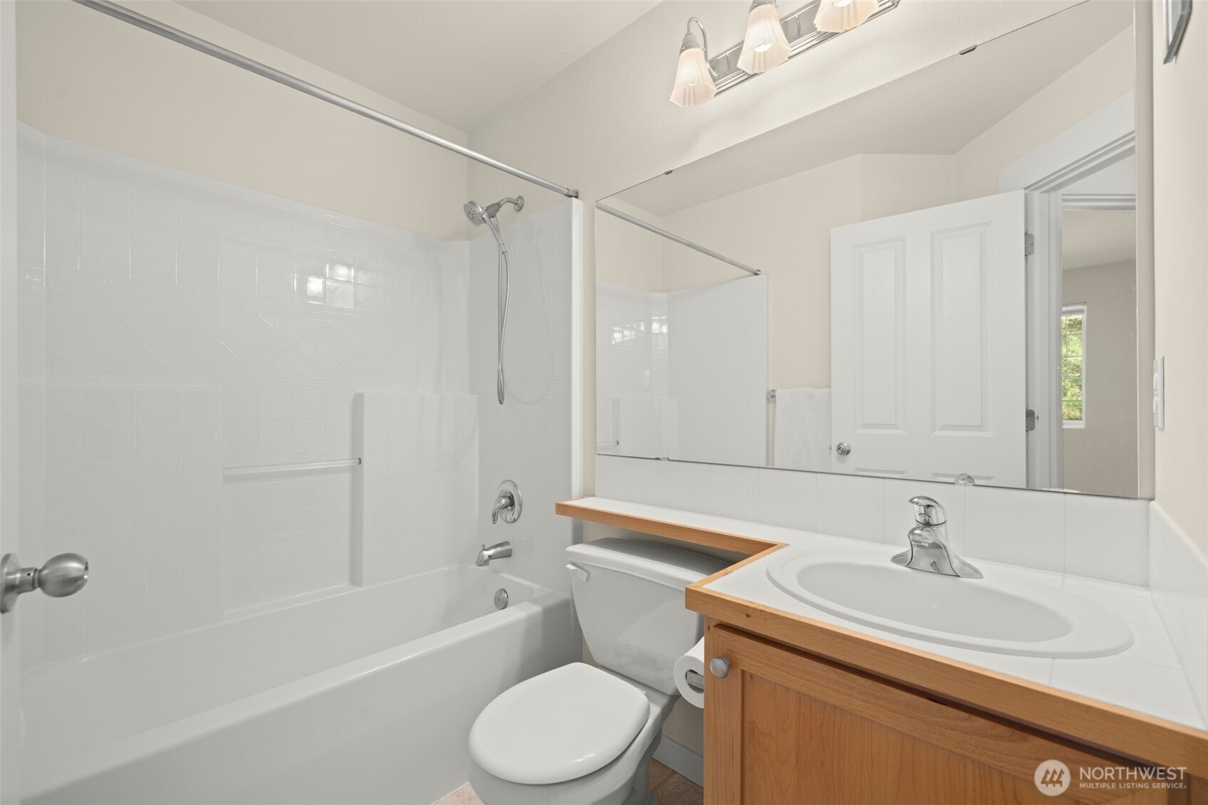 23120 Southeast Black Nugget Road, Unit E1 Issaquah, WA 98029 - Photo 22 of 39 a bathroom with a sink toilet vanity and shower