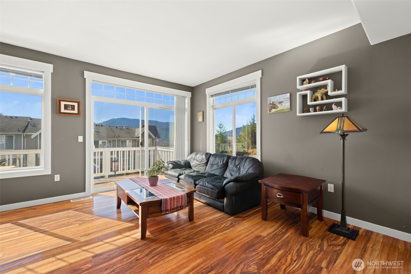 23120 Southeast Black Nugget Road, Unit E1 Issaquah, WA 98029 - Photo 7 of 39 a living room with furniture a window and a flat screen tv