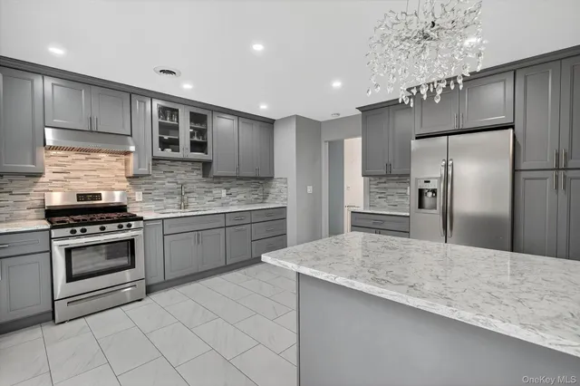 a kitchen with a sink stainless steel appliances and cabinets