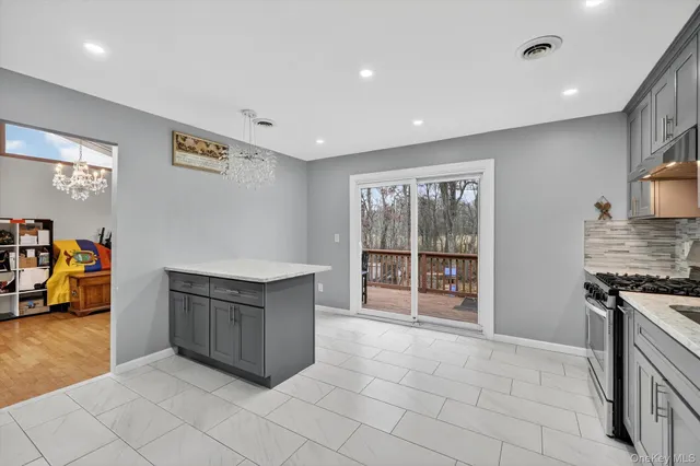 a large kitchen with stainless steel appliances granite countertop a large counter top and a stove