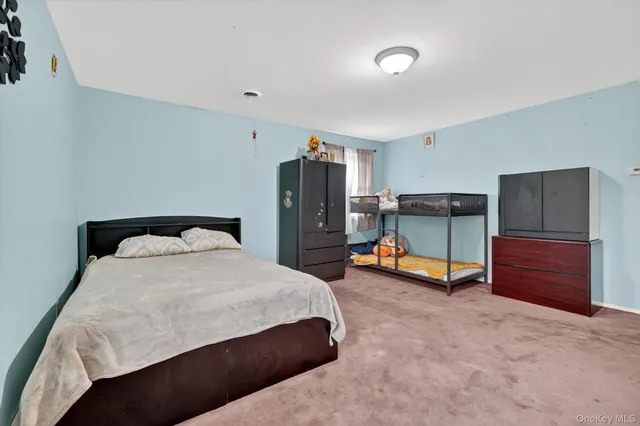 a bedroom with a bed and dresser