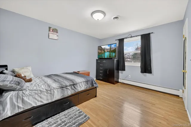 a bedroom with a bed and window