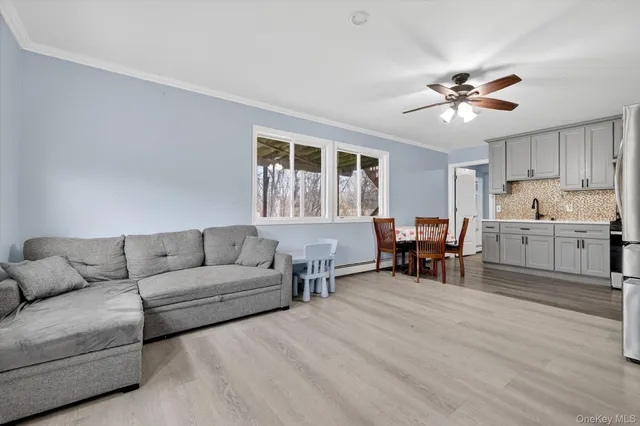 a living room with furniture and kitchen view