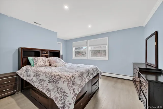 a bedroom with a large bed and a window