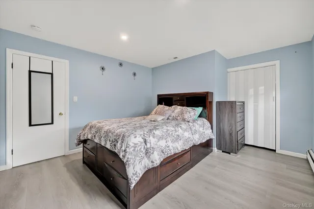 a bedroom with a bed and cabinet