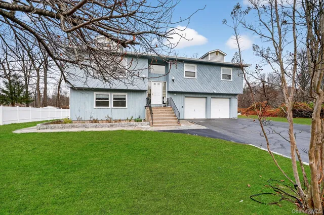 a front view of a house with a garden and yard