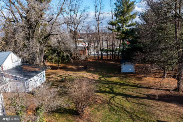 a living room with furniture and a book shelf