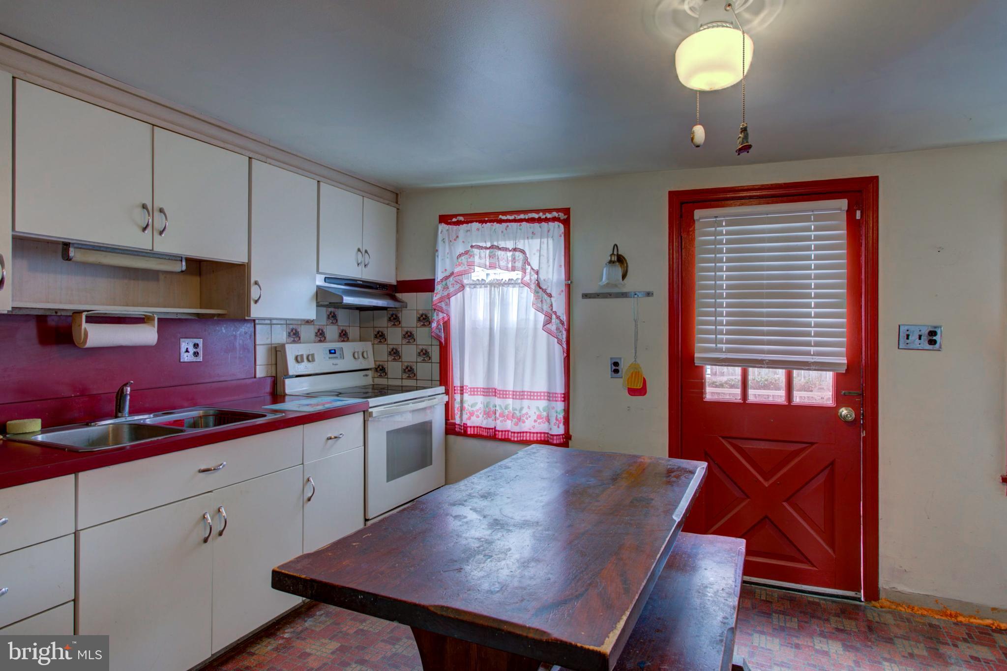 193 Cochran Street Cochranville, PA 19330 - Photo 19 of 57 a kitchen with a table chairs sink and cabinets