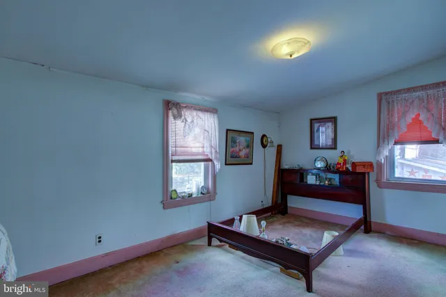 a bedroom with a bed and a wooden floor