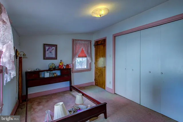 a view of room with hardwood floor and a window