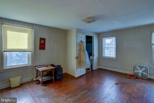 a living room with furniture a couch and large windows
