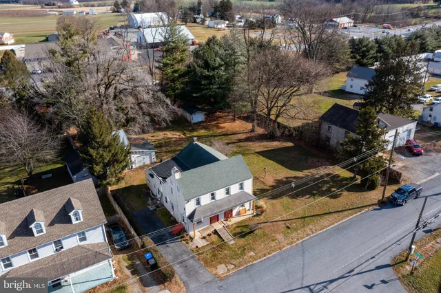 an aerial view of a house with a yard