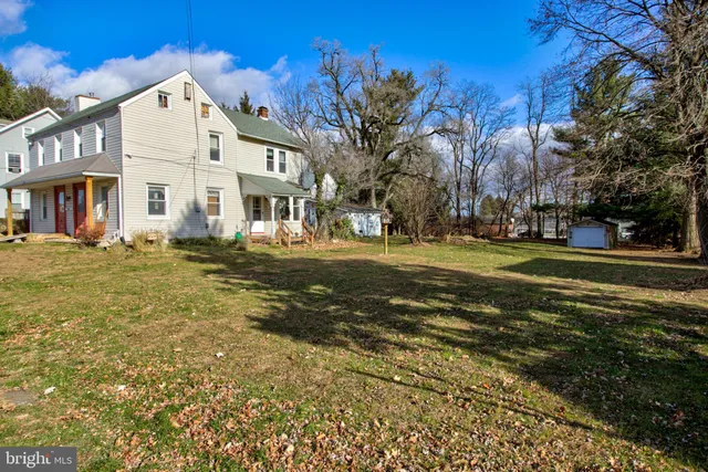 a view of a wooden house with a yard