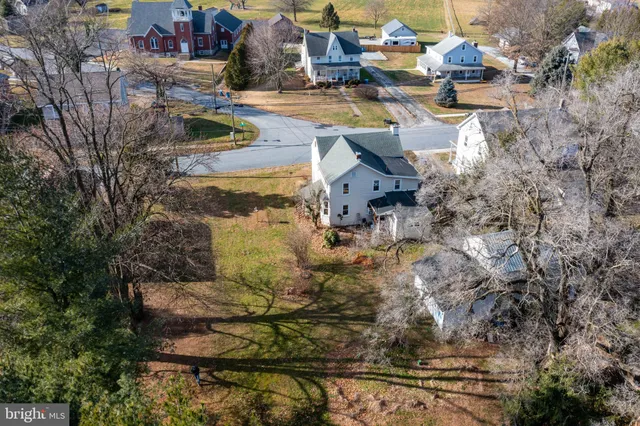 a view of a lake with lawn chairs