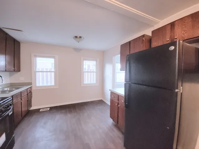 a kitchen with a refrigerator and a sink