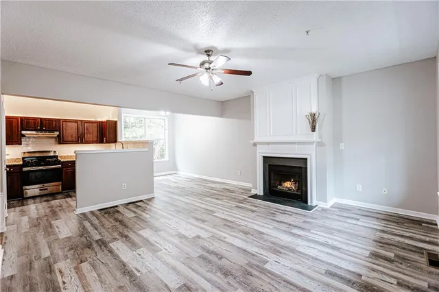 a view of a kitchen with a ceiling fan fireplace and a window