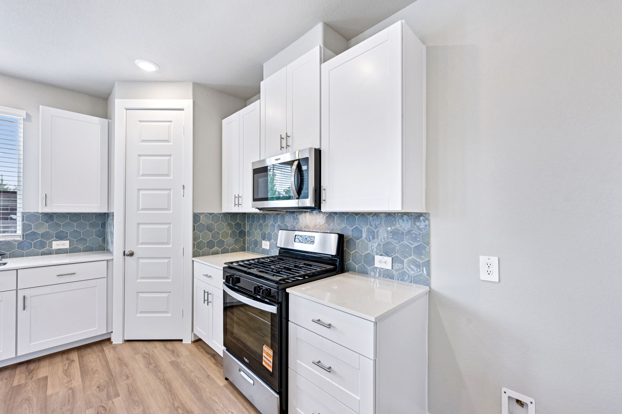 10032 Rustic Charm Street Houston, TX 77080 - Photo 12 of 40 a kitchen with white cabinets stainless steel appliances and sink
