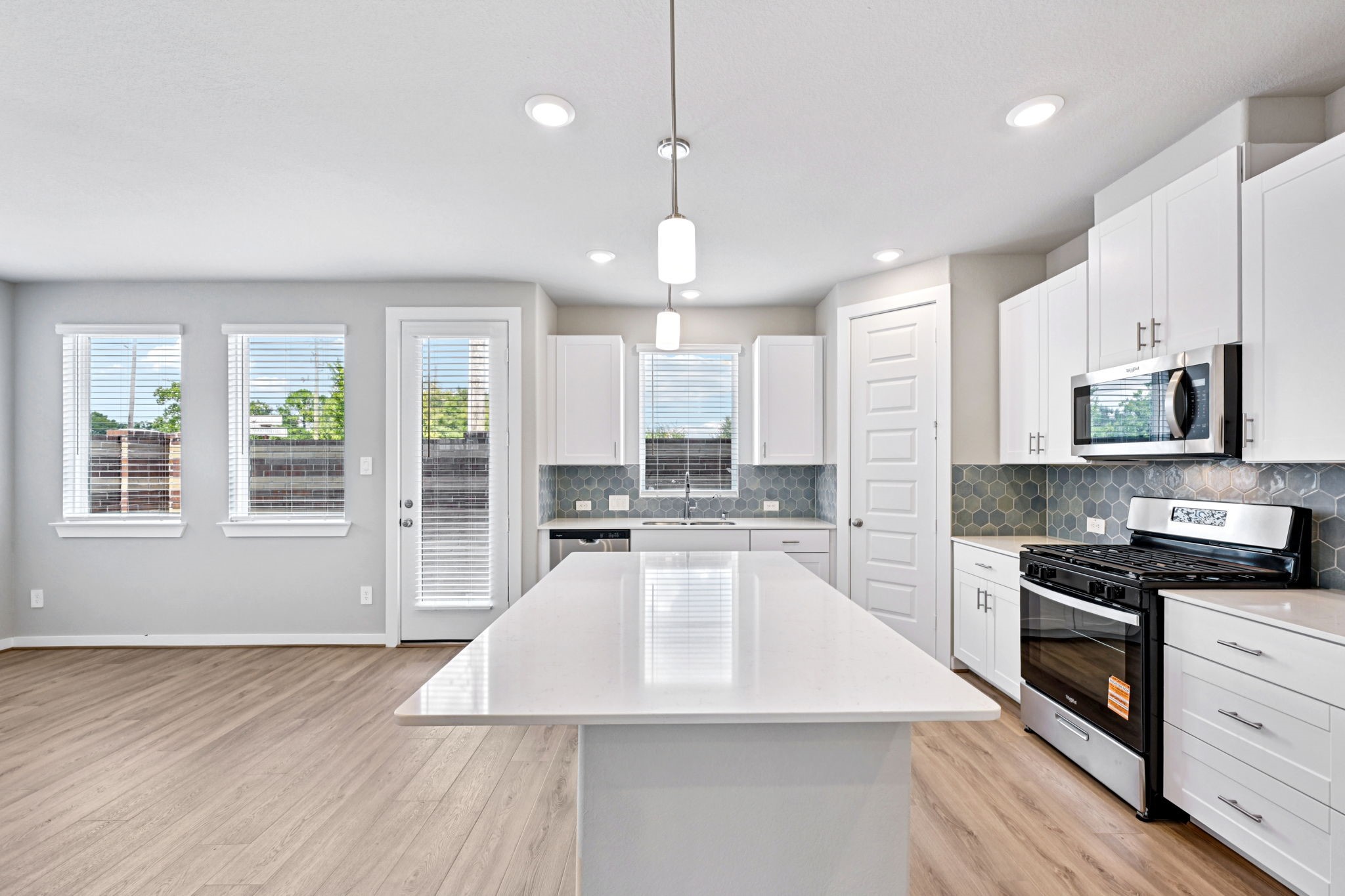 10032 Rustic Charm Street Houston, TX 77080 - Photo 13 of 40 a large kitchen with granite countertop a stove oven and a sink with granite countertops