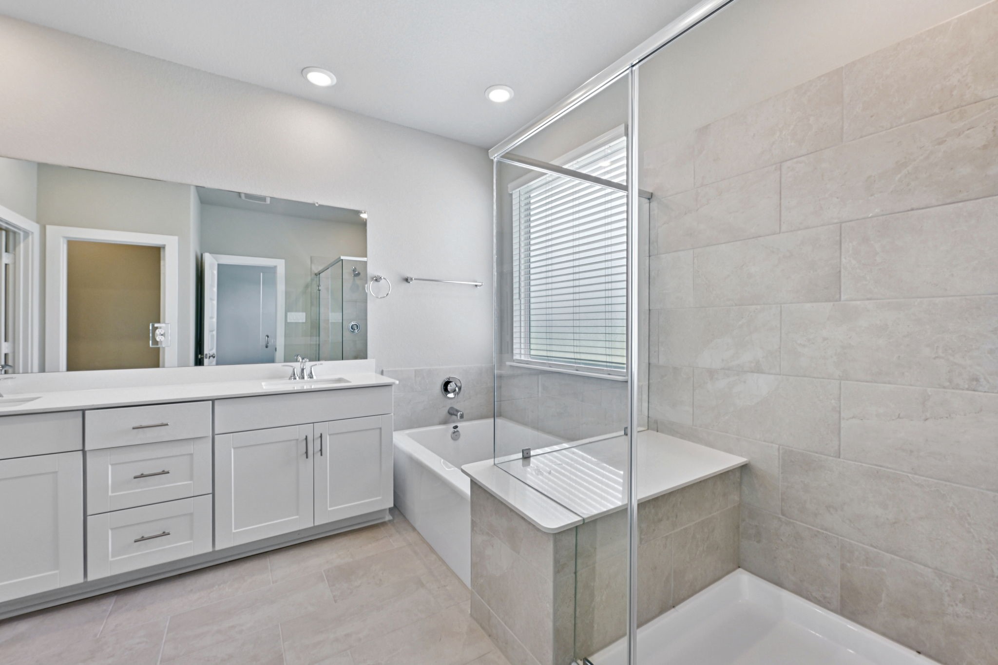 10032 Rustic Charm Street Houston, TX 77080 - Photo 25 of 40 a spacious bathroom with a double vanity sink a mirror and a bathtub