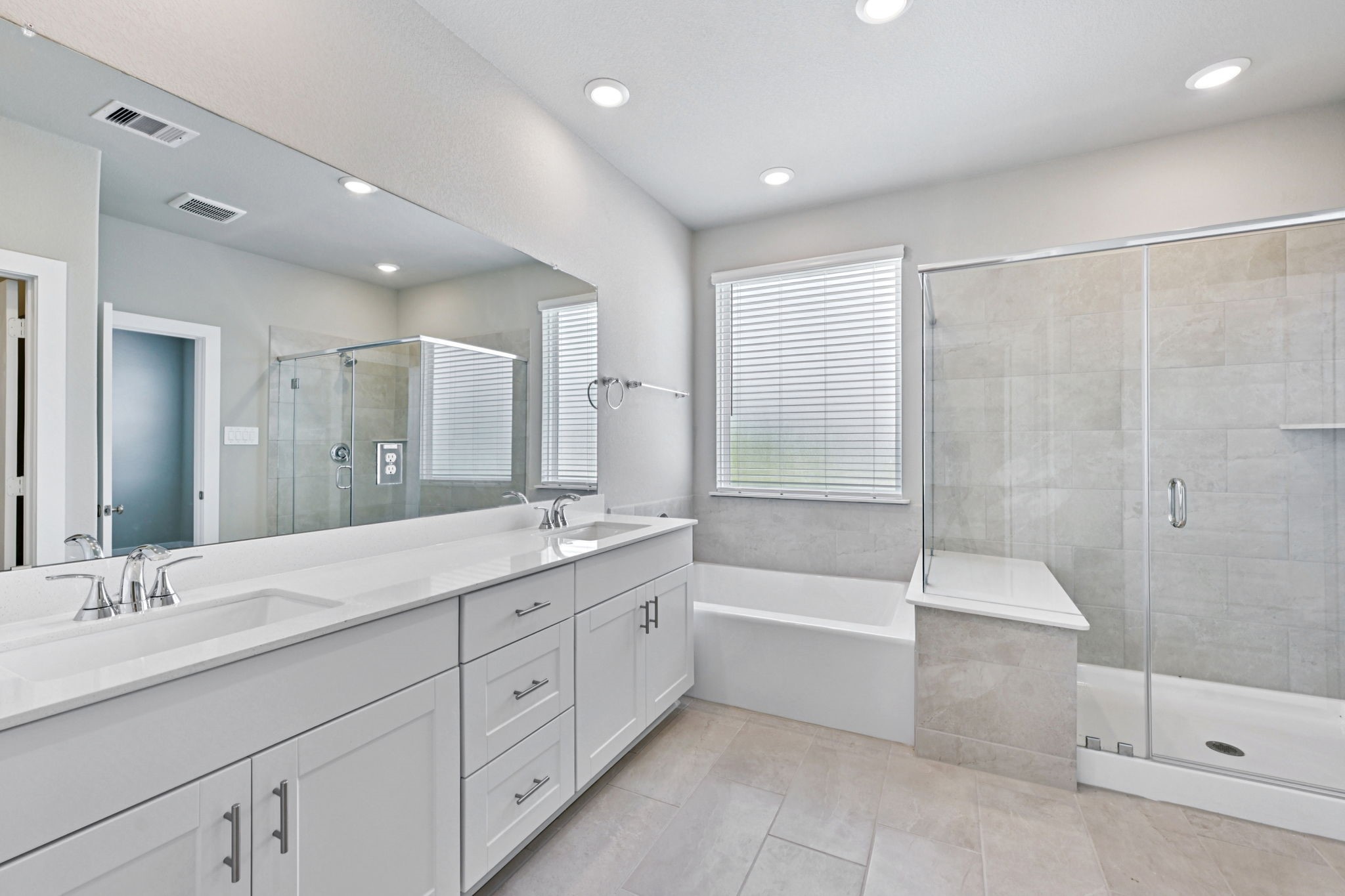 10032 Rustic Charm Street Houston, TX 77080 - Photo 26 of 40 a bathroom with a granite countertop sink a large mirror a shower and bathtub