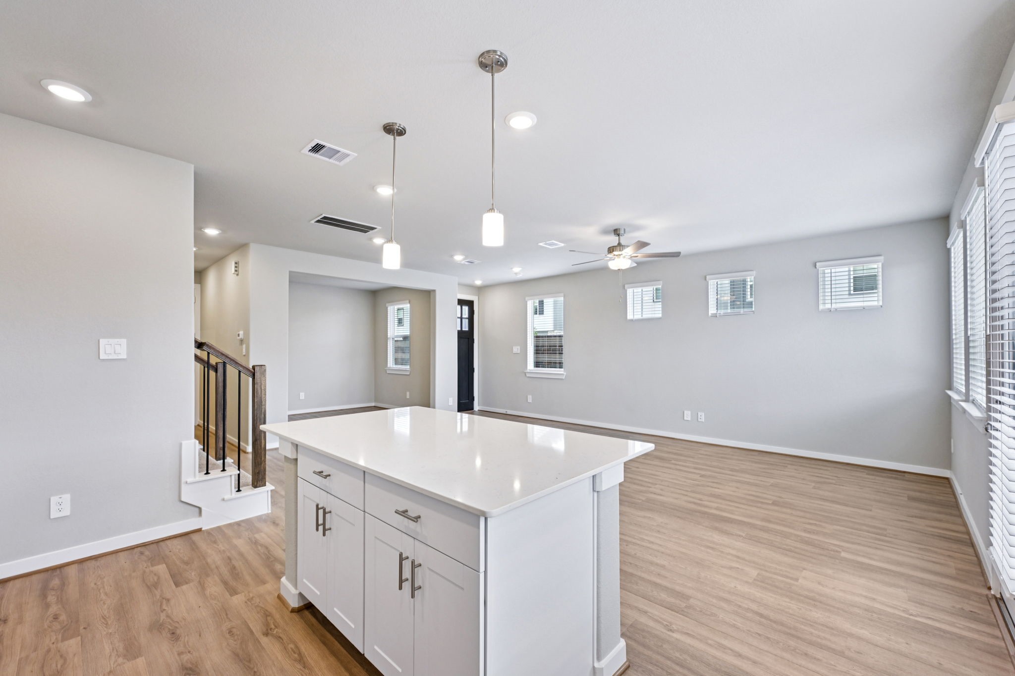 10032 Rustic Charm Street Houston, TX 77080 - Photo 6 of 40 a large kitchen with kitchen island a stove a sink dishwasher and a refrigerator with wooden floor
