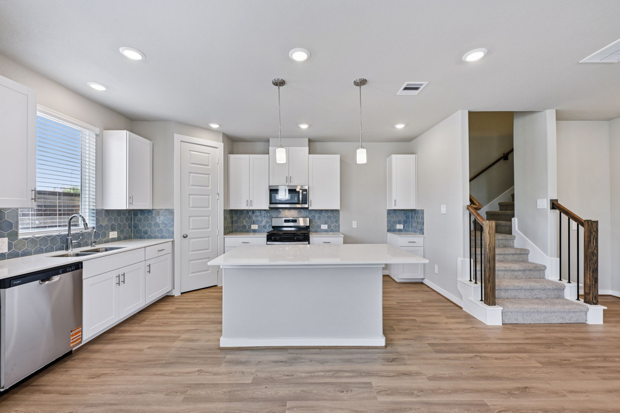 10032 Rustic Charm Street Houston, TX 77080 - Photo 7 of 40 a large kitchen with stainless steel appliances kitchen island granite countertop a large island in the center