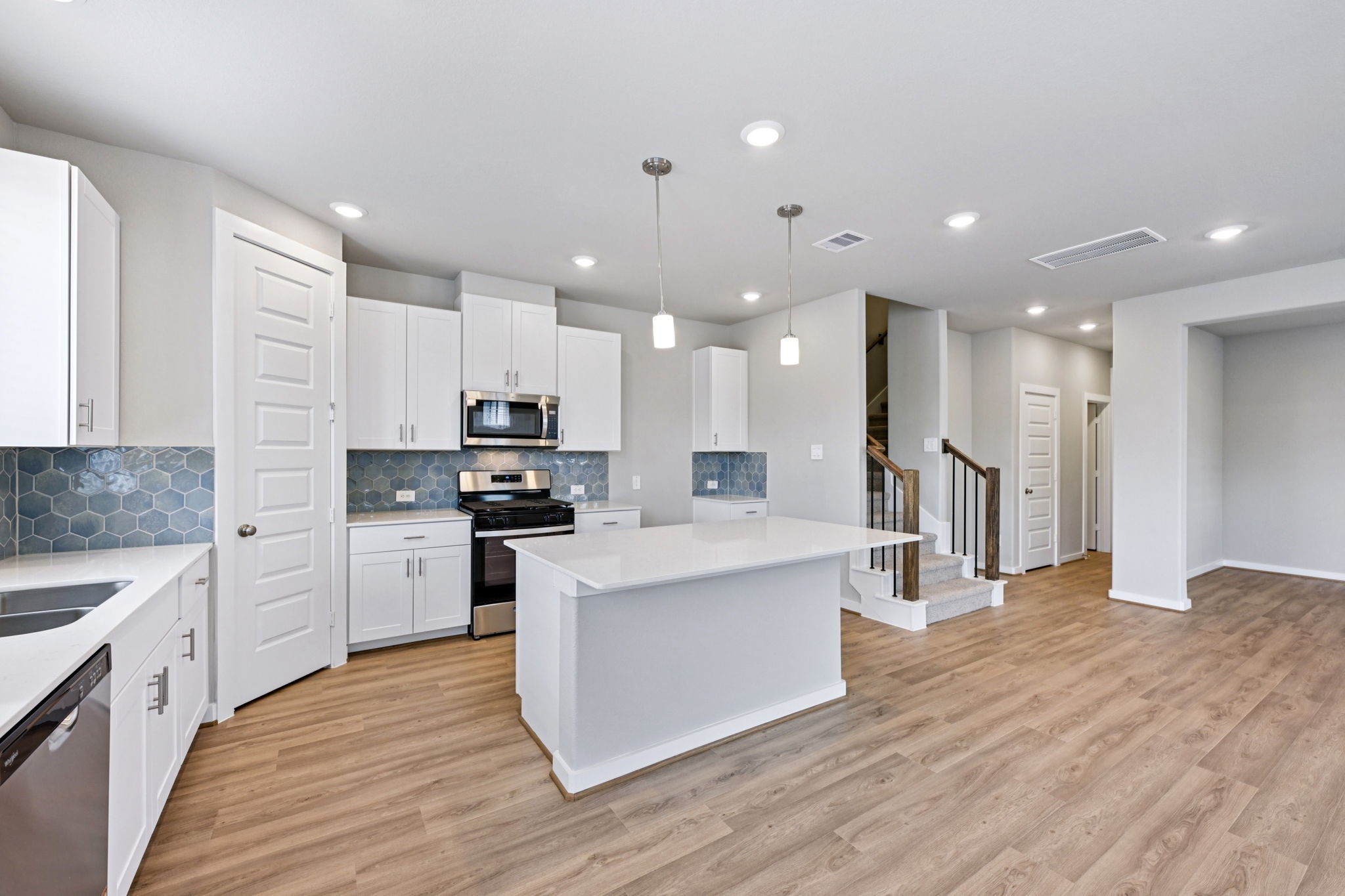 10032 Rustic Charm Street Houston, TX 77080 - Photo 8 of 40 a large kitchen with stainless steel appliances kitchen island a large counter top and a stove top oven