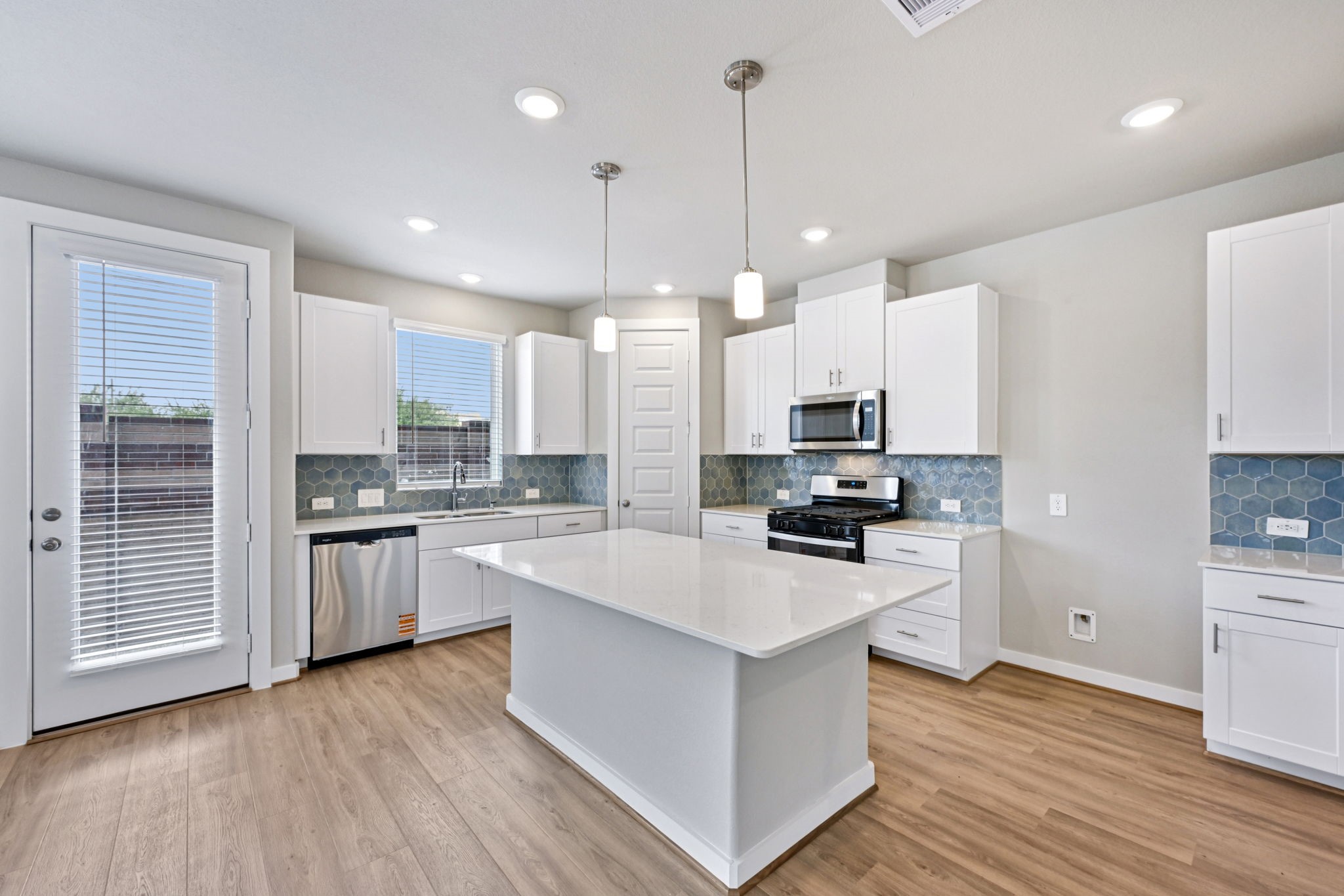 10032 Rustic Charm Street Houston, TX 77080 - Photo 9 of 40 a kitchen with a sink wooden floor and kitchen view