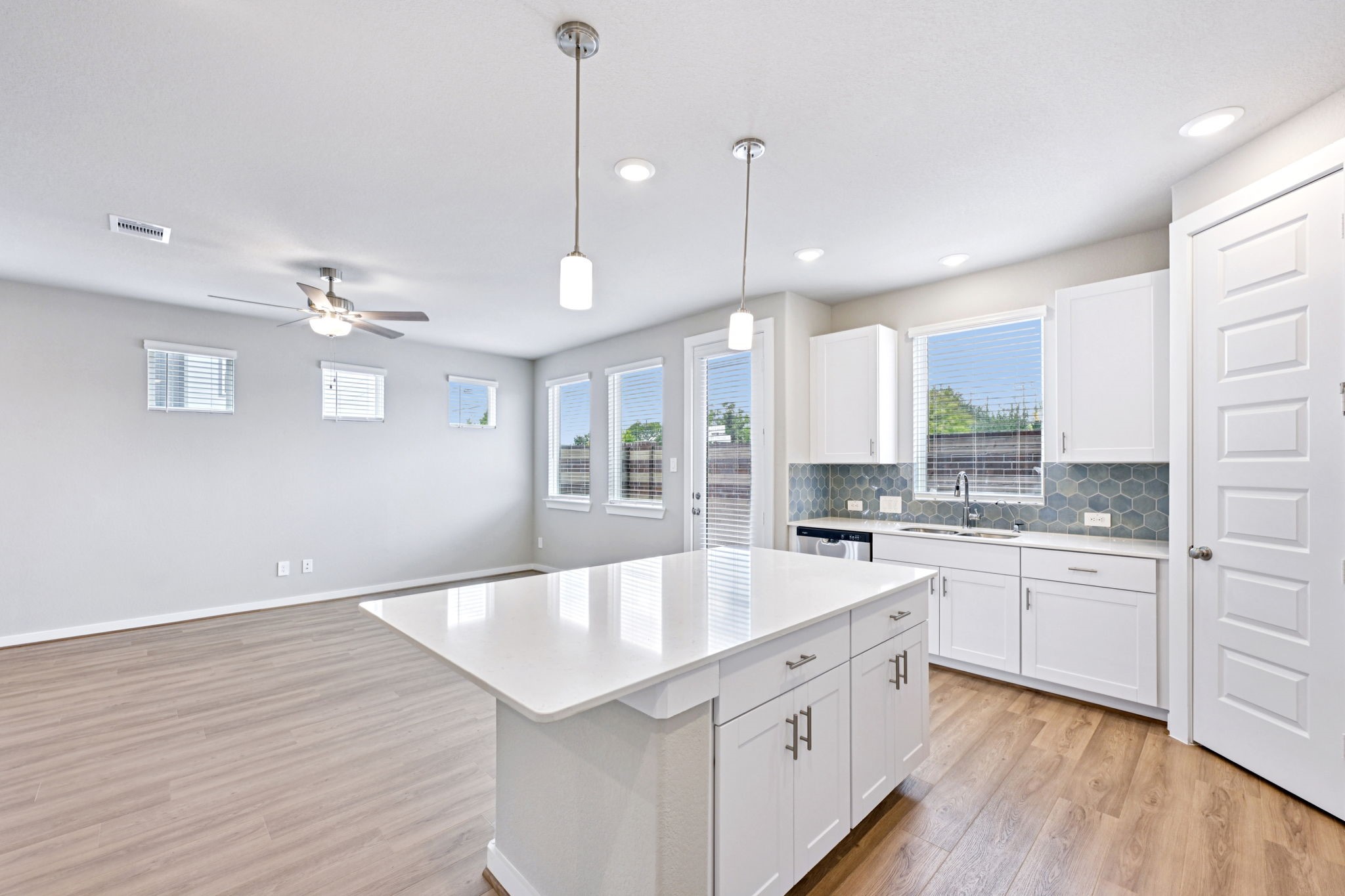 10032 Rustic Charm Street Houston, TX 77080 - Photo 10 of 40 a large kitchen with kitchen island a stove a sink a center island and wooden floor