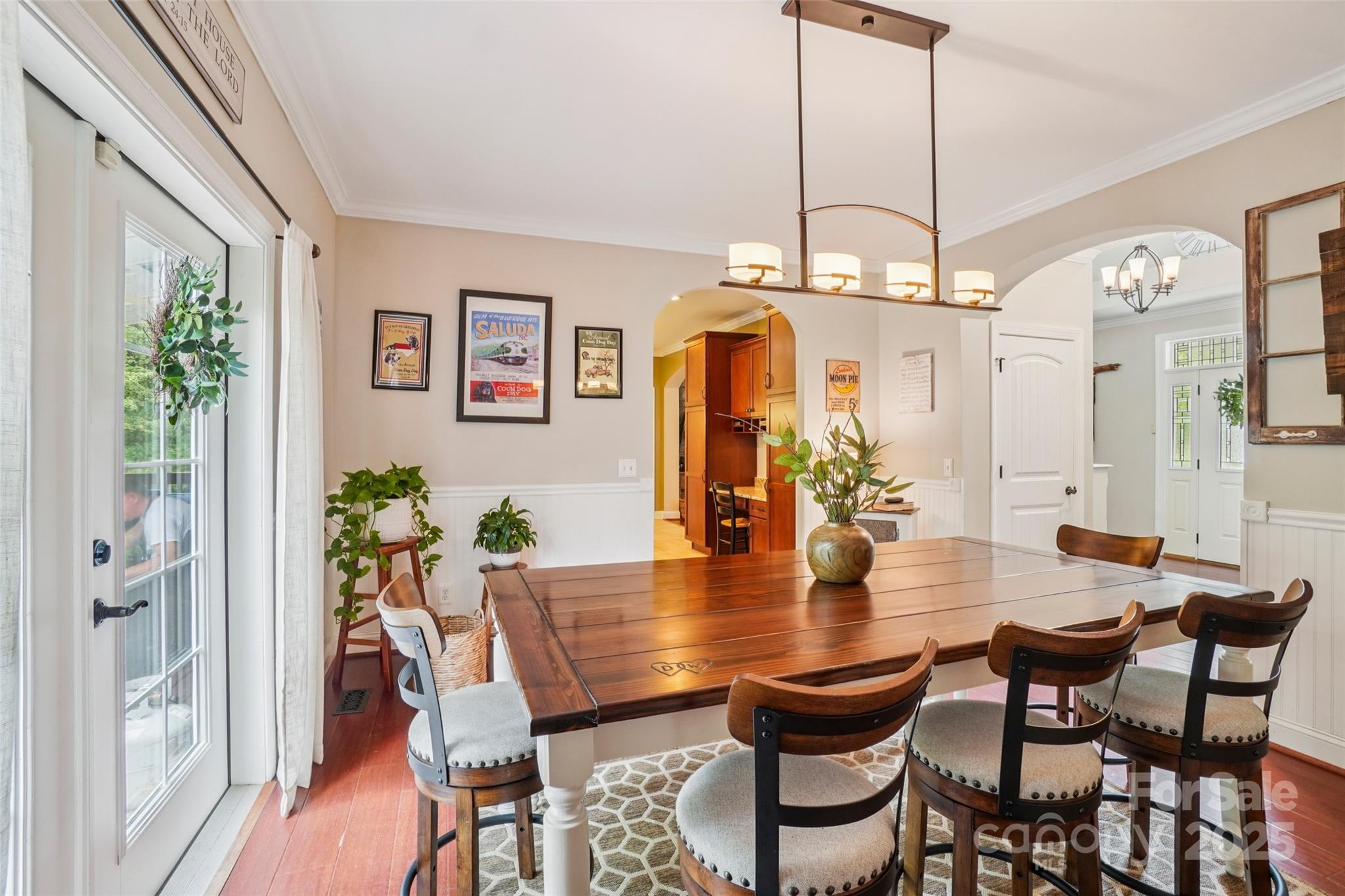813 Beech Tree Place Hendersonville, NC 28792 - Photo 14 of 46 a view of a dining room with furniture a chandelier and wooden floor