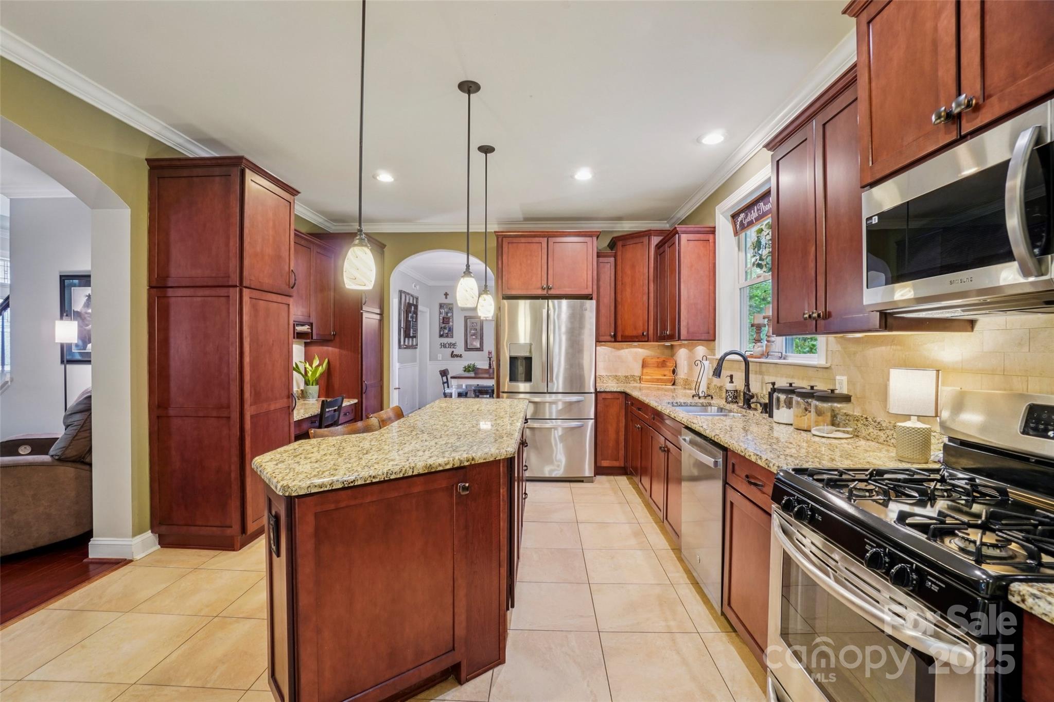 813 Beech Tree Place Hendersonville, NC 28792 - Photo 16 of 46 a large kitchen with stainless steel appliances granite countertop wooden cabinets a sink a stove and a refrigerator