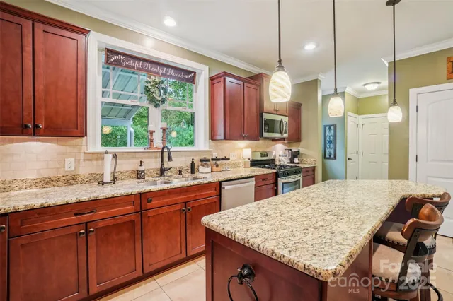 a kitchen with stainless steel appliances granite countertop wooden cabinets a sink and dishwasher