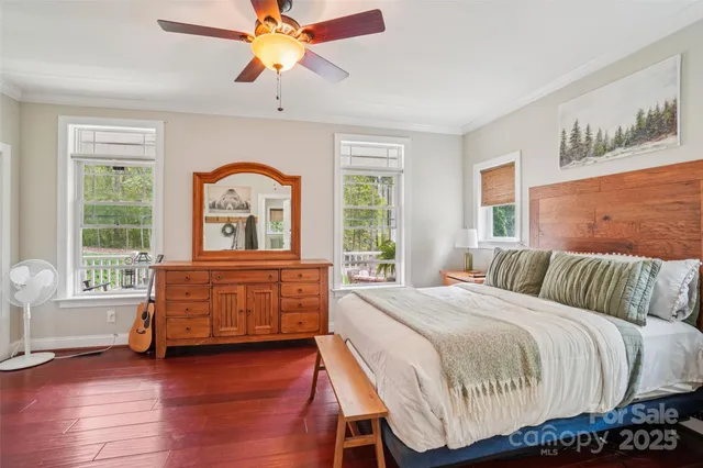 a bedroom with a bed and a dresser next to a window