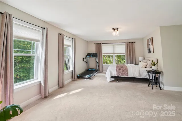 a bedroom with furniture and a large window