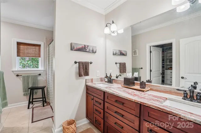 a bathroom with a double vanity sink and a mirror