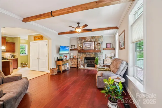a living room with furniture a fireplace and a window