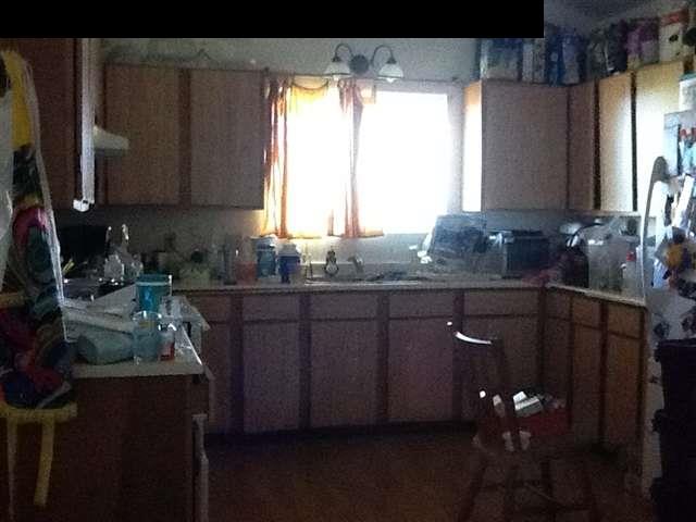 944 Kokomo Road Haiku, HI 96708 - Photo 9 of 11 a kitchen with granite countertop a sink cabinets and wooden floor