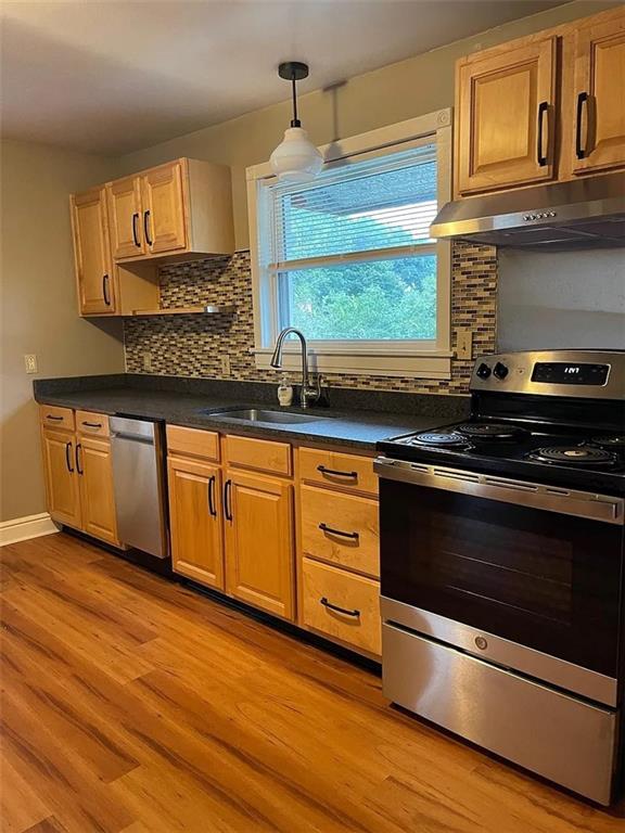 a kitchen with granite countertop wooden cabinets and a stove