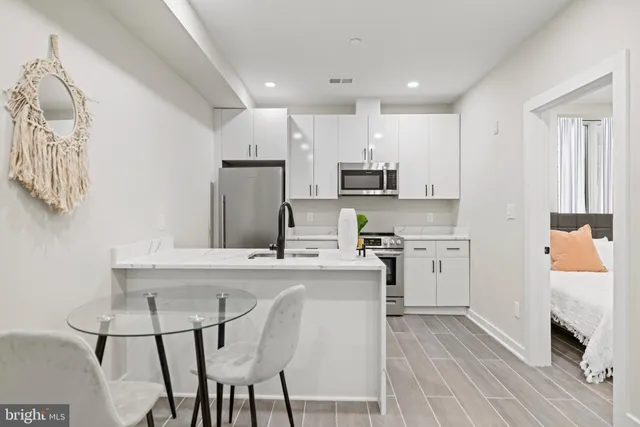 a kitchen with stainless steel appliances granite countertop a white stove top oven a sink and dishwasher