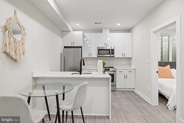a kitchen with a sink cabinets and wooden floor