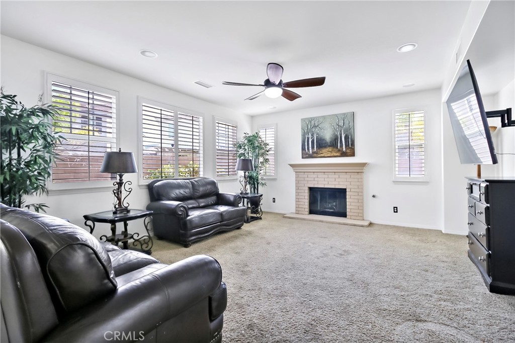 32001 Whitetail Lane Temecula, CA 92592 - Photo 15 of 28 a living room with furniture a window and a fireplace