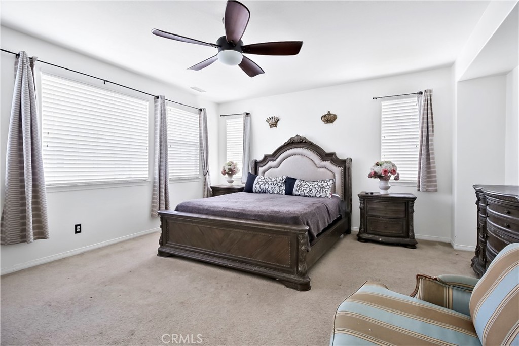 32001 Whitetail Lane Temecula, CA 92592 - Photo 18 of 28 a bedroom with a bed and a chandelier