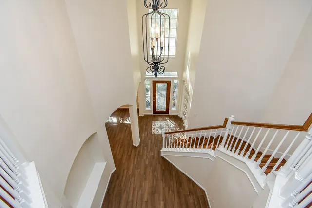 a view of a bedroom with wooden floor