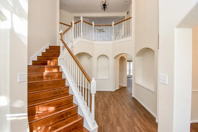 a view of entryway and hall with wooden floor
